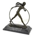 A reproduction bronzed metal figure, 'The Hoop Dancer', indistinctly signed, on rectangular marble