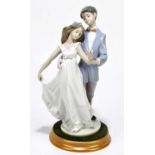 LLADRO; a figure group, 'Ten Years Together', height 28cm, with a circular base. Condition Report: