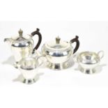 WAKELY & WHEELER; an Elizabeth II hallmarked silver four piece tea service, with a cast band of