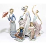 LLADRO; four figures to include two large examples, one modelled as an Edwardian lady with parasol