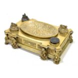 A French 19th century gilt metal desk stand, with raised oval shaped bowl to the centre, flanked