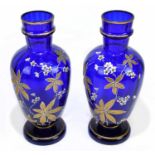 A pair of late Victorian blue glass vases, enamel and gilt decorated with floral sprays, height 31cm