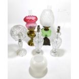 Three cut glass table lamps, one with a domed shade, tallest 39cm, with a Victorian oil lamp with