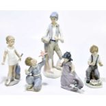 NAO; three figures to include a boy playing with a model plane, height 16cm, also two Spanish