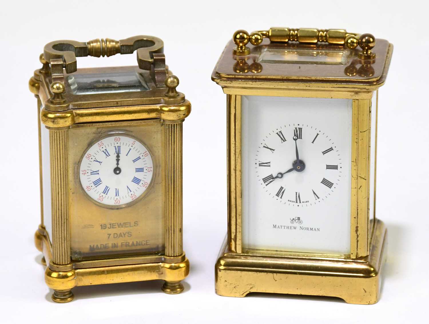 MATTHEW NORMAN; a brass cased carriage clock, the enamel dial set with Roman numerals, height 8cm,