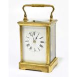 A 19th century French brass cased repeating carriage clock, the enamel dial set with Roman numerals,