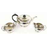 A George V hallmarked silver three piece tea service with planished decoration, Sheffield 1927,