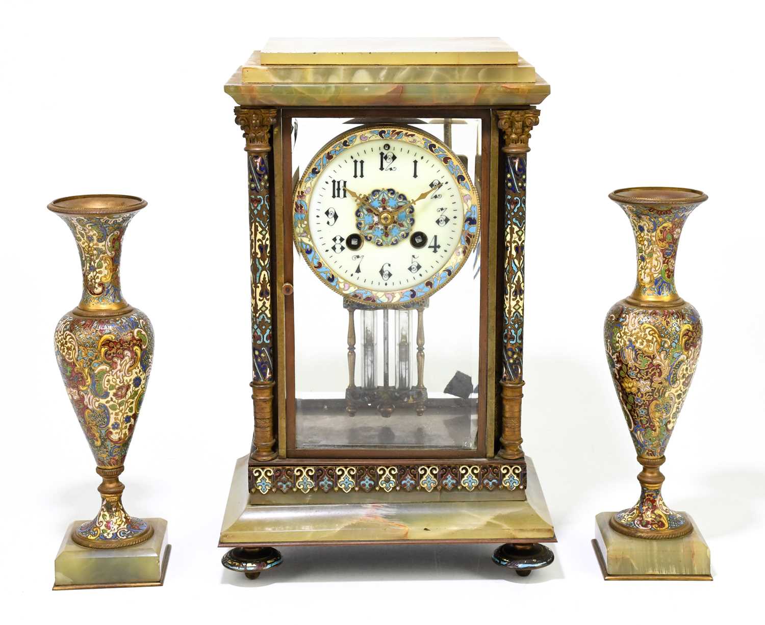 A 19th century French onyx and champleve enamel three piece clock garniture, the four glass clock of