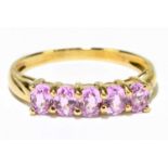 A 9ct yellow gold five stone pink sapphire ring, size P, approx 1.9g.