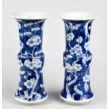 A pair of late 19th century Chinese blue and white porcelain Gu vases painted with prunus flowers on