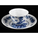 A Chinese blue and white porcelain tea bowl and saucer decorated with landscape scene and floral