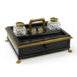 A William IV brass mounted and inlaid ebonised desk stand, with two brass lidded cut glass