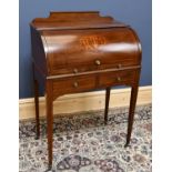 An Edwardian inlaid mahogany roll top desk with pull out slide enclosing pigeon holes and two