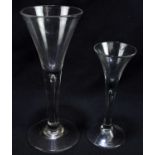 Two 18th century ale glasses, each with air bubble to the stem, height 19cm and 14cm (2).Condition