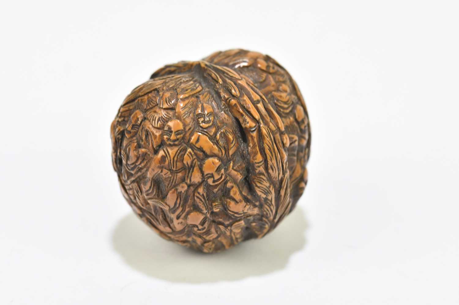 A Japanese carved walnut, decorated with figures within floral detail, height 3cm. - Image 3 of 4