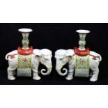 A pair of Chinese Famille Rose porcelain models of elephants with Gu shaped vases terminating from
