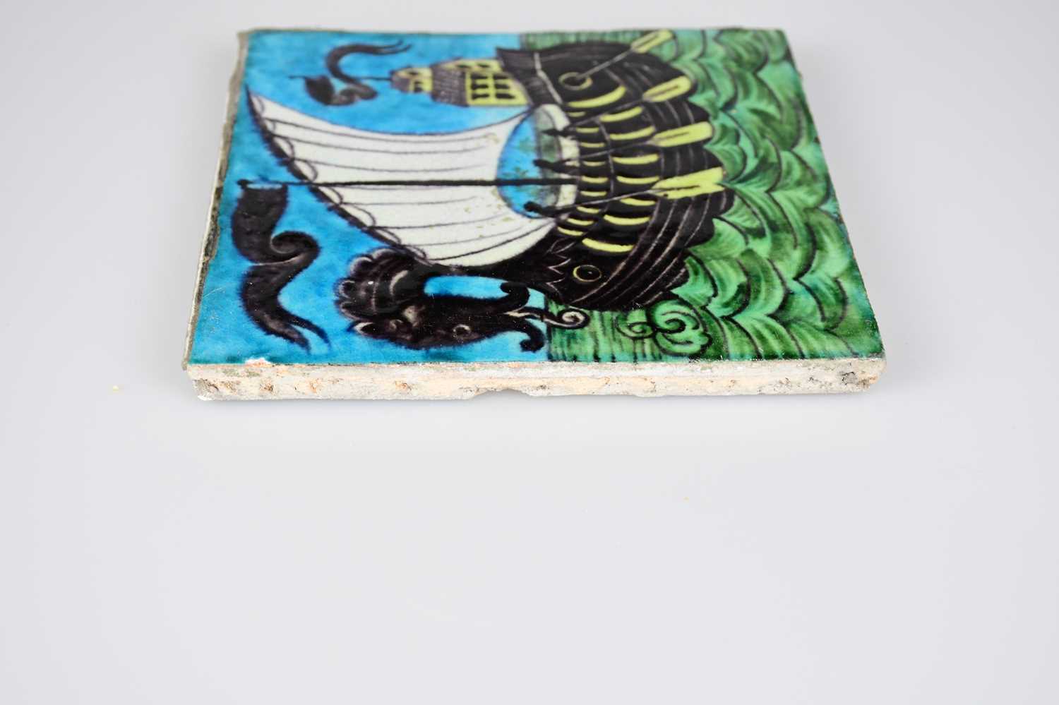 WILLIAM DE MORGAN; an Art Pottery tile painted with a galleon and three sailors with paddles, in - Image 4 of 6