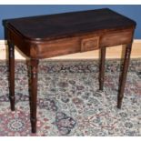 A Regency mahogany fold over card table, inlaid with Prince of Wales feathers, on turned legs,