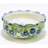 WILLIAM MOORCROFT FOR JAMES MACINTYRE & CO; a footed bowl with wavy rim decorated in the '