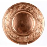 KESWICK SCHOOL OF INDUSTRIAL ARTS; an Arts and Crafts copper dish, decorated with floral sprays,