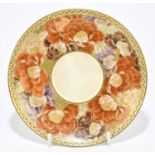 A Japanese Satsuma Meiji period saucer, decorated with flowers, signed to the back, diameter 13cm.