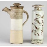 † CHRIS ASTON; a tall stoneware jar and screw top cover covered in pale grey glaze with iron and