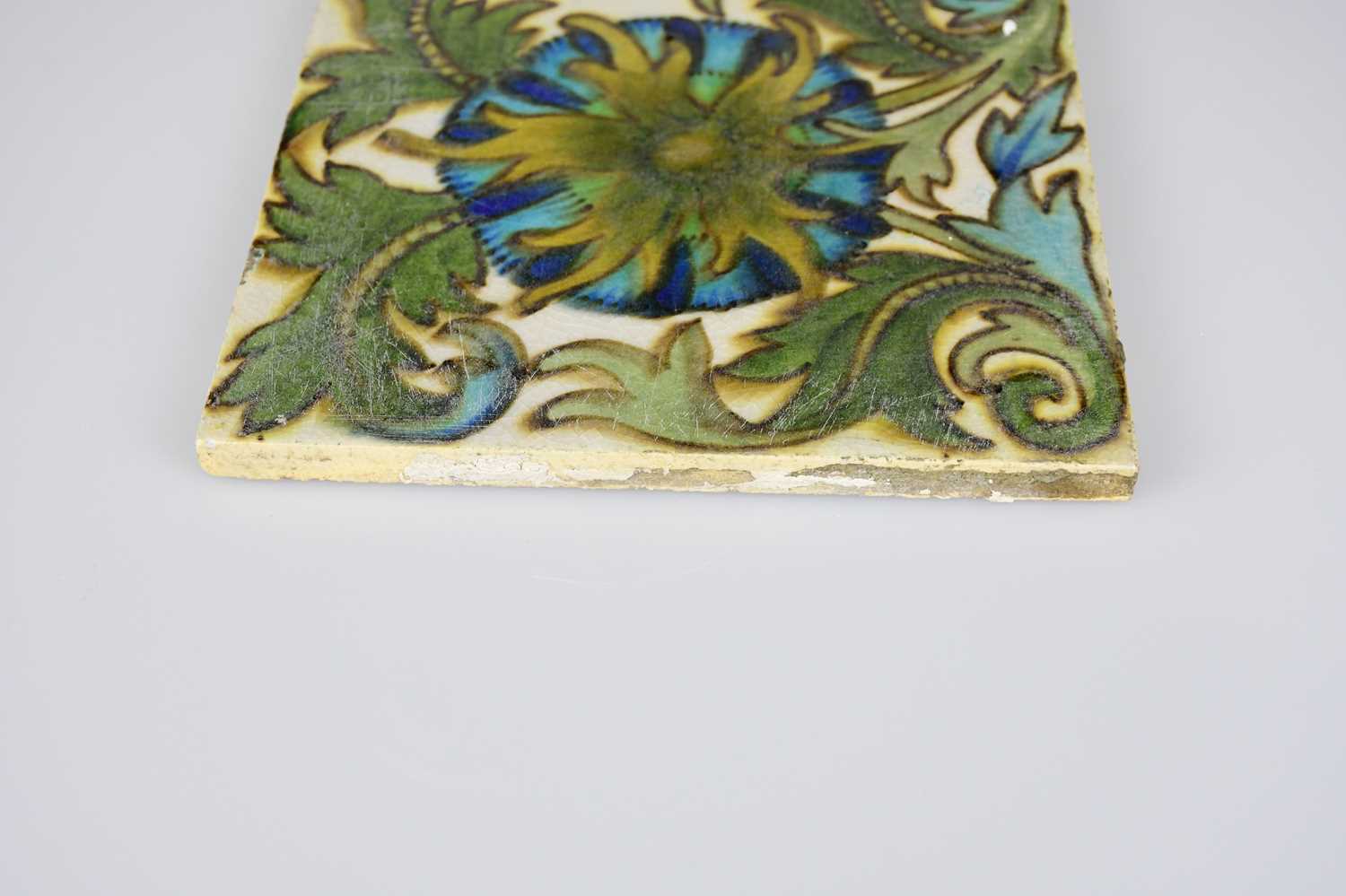 ATTRIBUTED TO MAW & CO; an Art Pottery tile painted with floral decoration, in shades of green, - Image 4 of 6