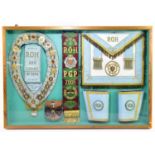 MASONIC INTEREST; a framed presentation to include an apron, armbands, sash, plaque and collar.