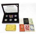 A WWI period Princess Mary Christmas tin containing five coins, half crown, florin, sixpence,