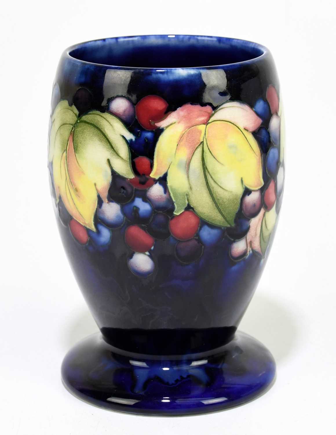 MOORCROFT; a 'Leaf and Berry' pattern vase, with a blue ground, impressed marks and painted Walter