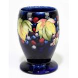MOORCROFT; a 'Leaf and Berry' pattern vase, with a blue ground, impressed marks and painted Walter