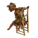 A late 19th century bronzed spelter figure of a young girl seated on a chair watching an insect