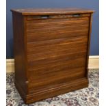 A 1930s oak tambour front cabinet, with hinged lid, height 103cm, width 92cm, depth 45cm.