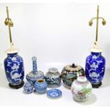 A pair of Chinese blue and white lamps, decorated with prunus, height 35cm, with a Chinese porcelain