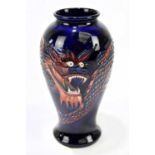 TREVOR CRITCHLOW FOR MOORCROFT; an inverted baluster form vase decorated in the 'Dragon' pattern,