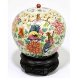 A 19th century Chinese globular Famille Rose jar and cover, painted throughout with floral sprays