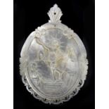 A carved mother of pearl religious panel of oval form depicting Jesus Christ and Mary, length 8.