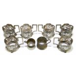 A set of six Persian white metal cup holders with niello and pierced floral decoration, unmarked,