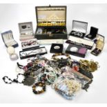 A large assortment of costume jewellery, mostly necklaces and bracelets, with a hallmarked silver