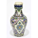 A Turkish Iznik earthenware vase, decorated with geometric panels, embellished with flowers,