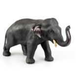 A bronze figure of an elephant, stamped to the underside, height 12cm.