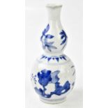 A Chinese blue and white double gourd vase, decorated with flowers and rockwork, height 20cm.