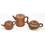 Three Chinese redware Yixing teapots and covers, the tallest a cylindrical example 13cm (3)