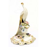 ROYAL CROWN DERBY; a model of a pheasant standing upon a floral encrusted urn, signed to the base '