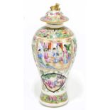 A 19th century Chinese Canton Famille Rose jar and cover decorated with figures inside panels,