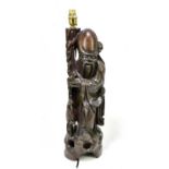 A Japanese carved hard wood lamp modelled as a sage, on pierced rockwork face, height 54cm.Condition