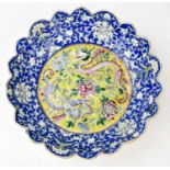 A 19th century Chinese Famille Rose bowl with scrolling border, decorated in enamels with a four