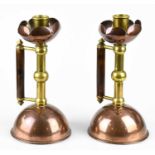 DR CHRISTOPHER DRESSER FOR BENHAM & FROUD; a pair of Arts and Crafts copper and brass chambersticks,