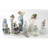 LLADRO; a collection of seven ceramic figures to include a girl holding a basket of flowers, no.