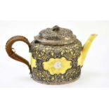 A late Victorian hallmarked silver clad porcelain teapot with rattan handle, pierced silver frame,